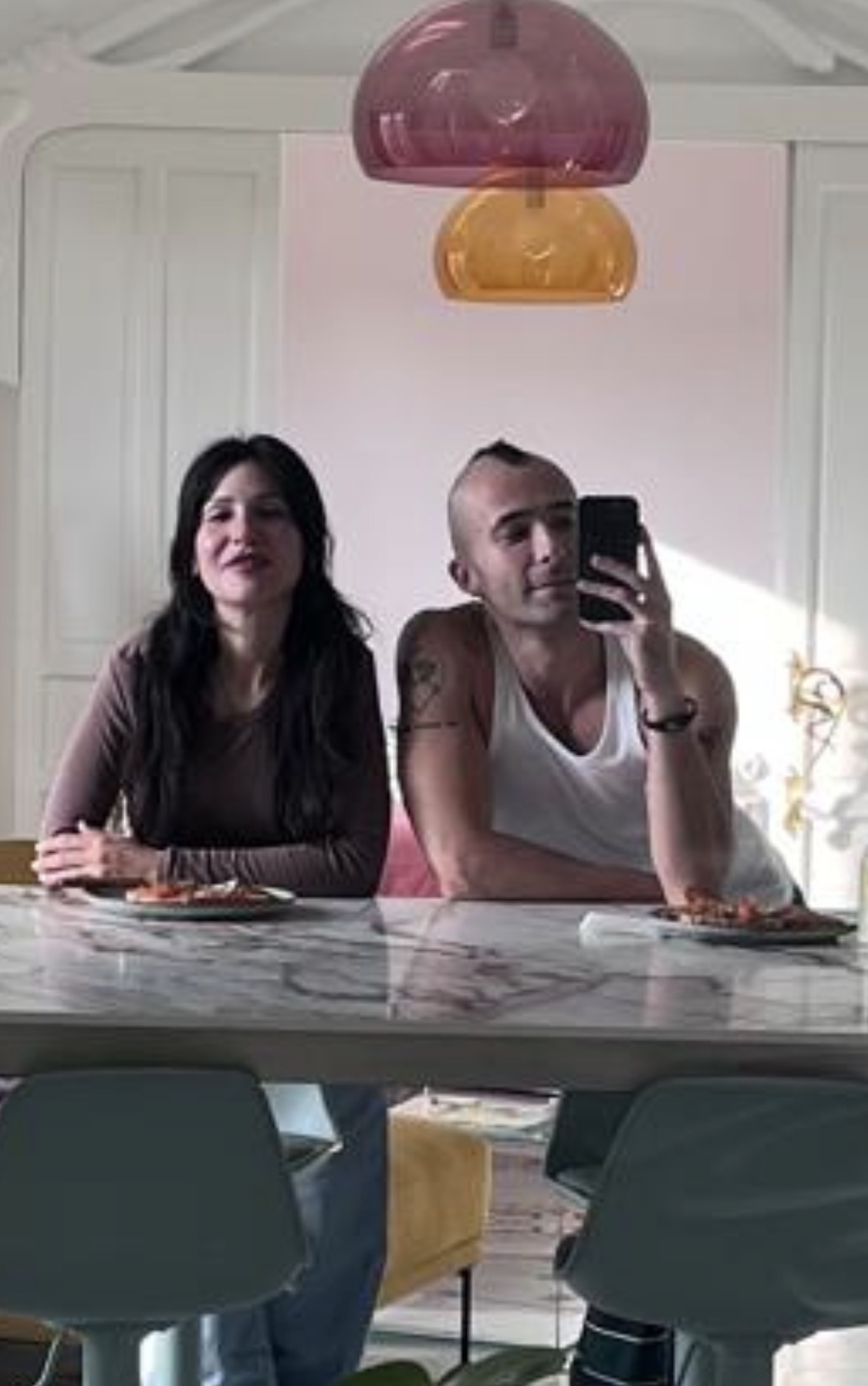 Maya with Sergio Castaño Peña, founder of Syndical Chamber, in front of the mirror at the atelier.