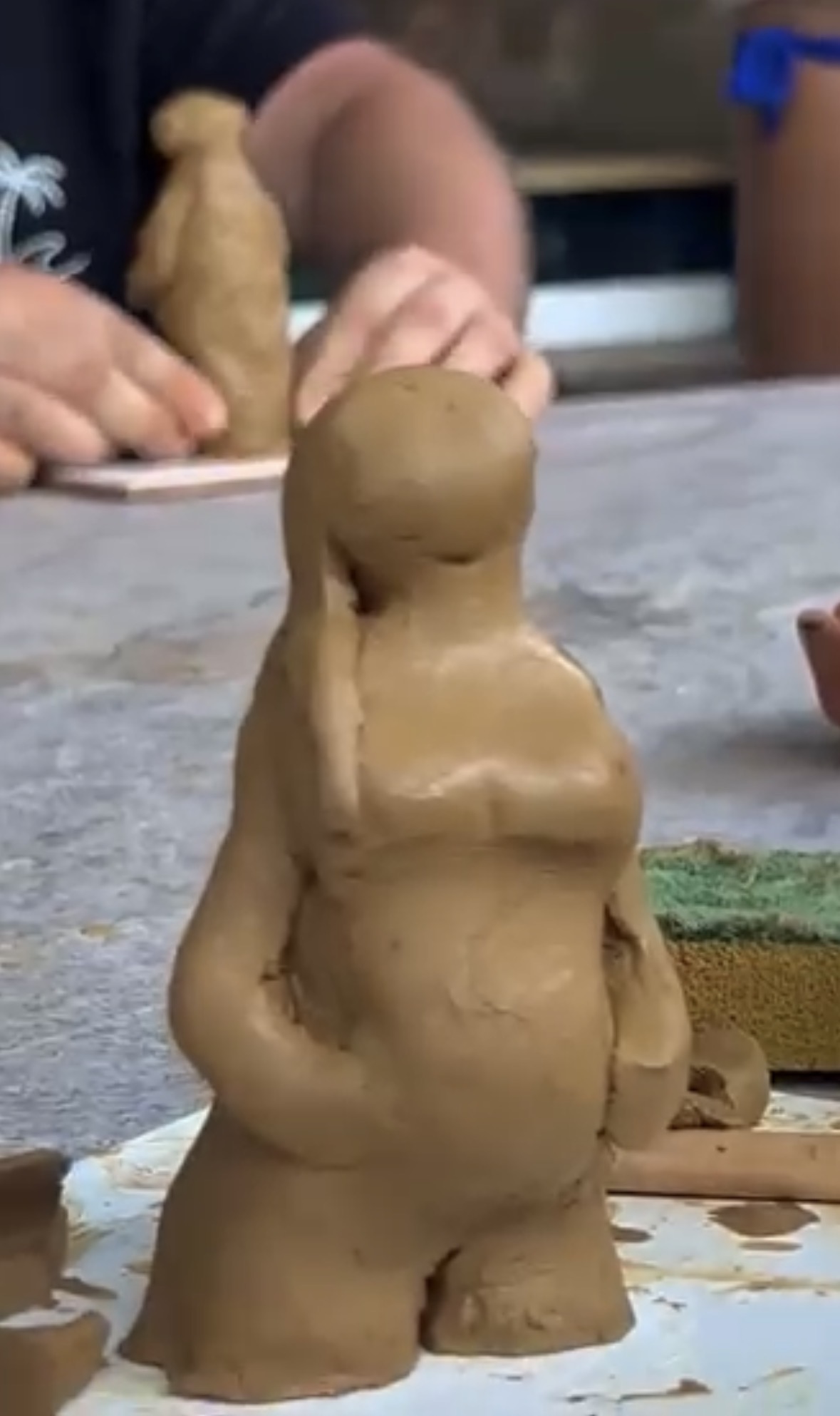 Hands shaping ceramics during a workshop.