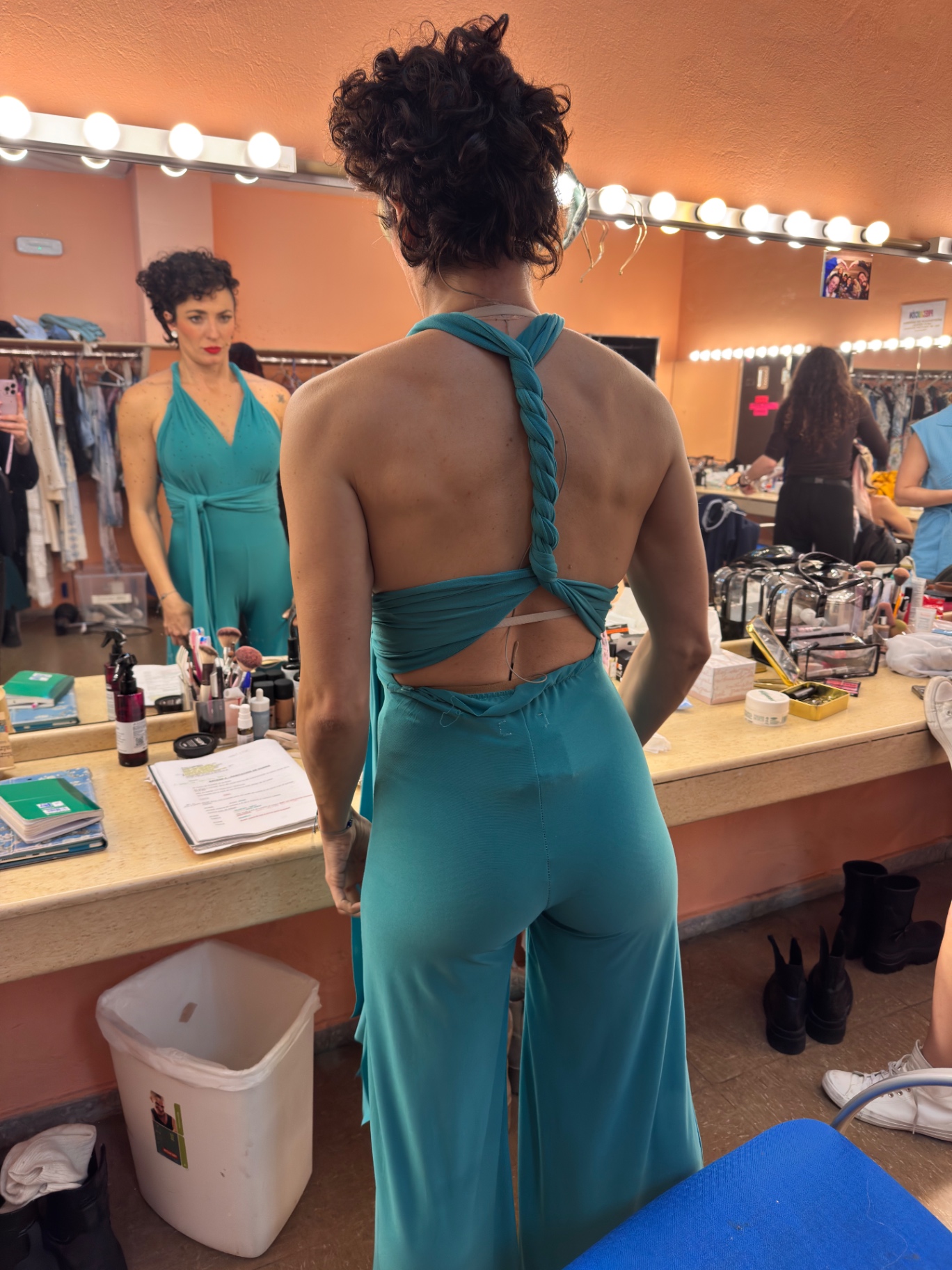 Costume fitting in a theatre dressing room