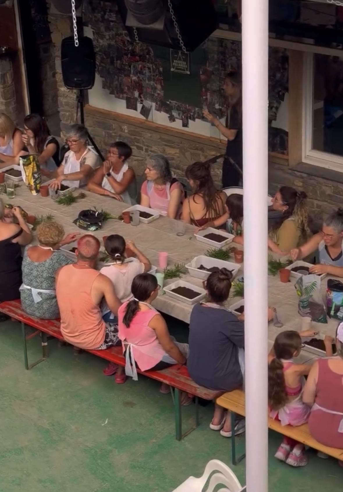 Group of participants sitting around a long table during a workshop at the camping in the Pyrenees.