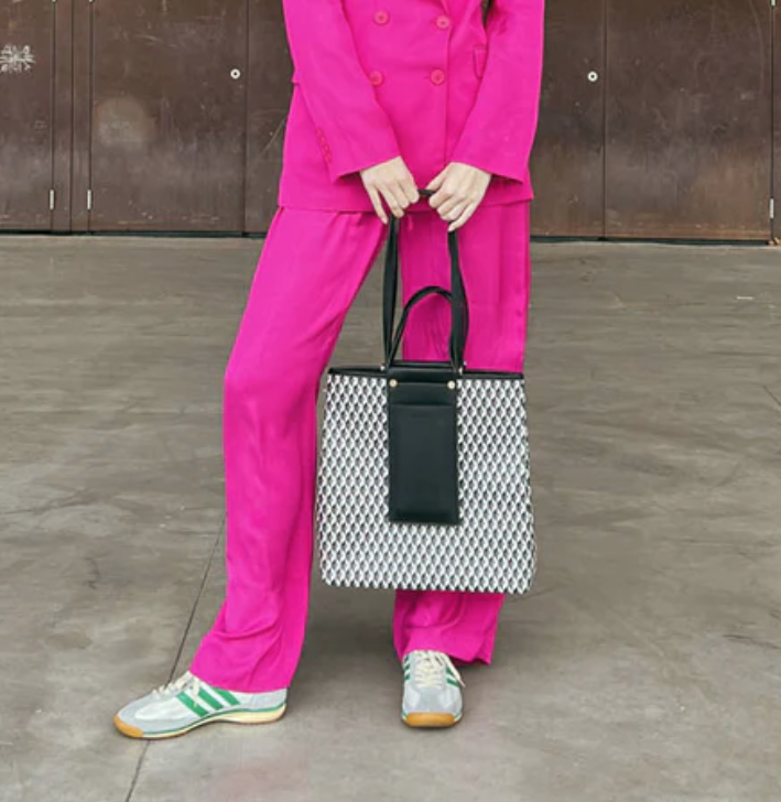 Lonbali printed tote bag worn with a pink suit.