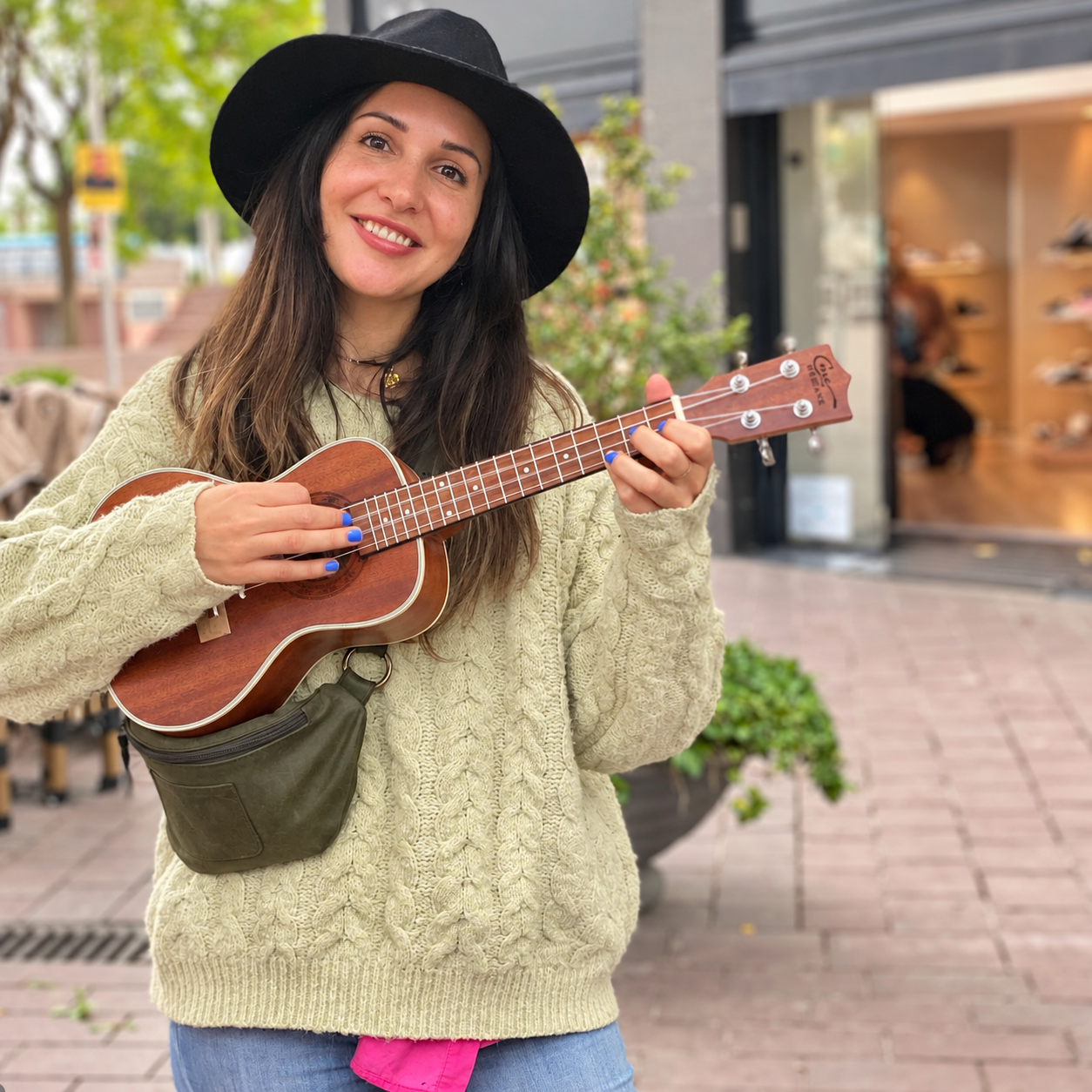 Portrait of Maya with her ukulele.