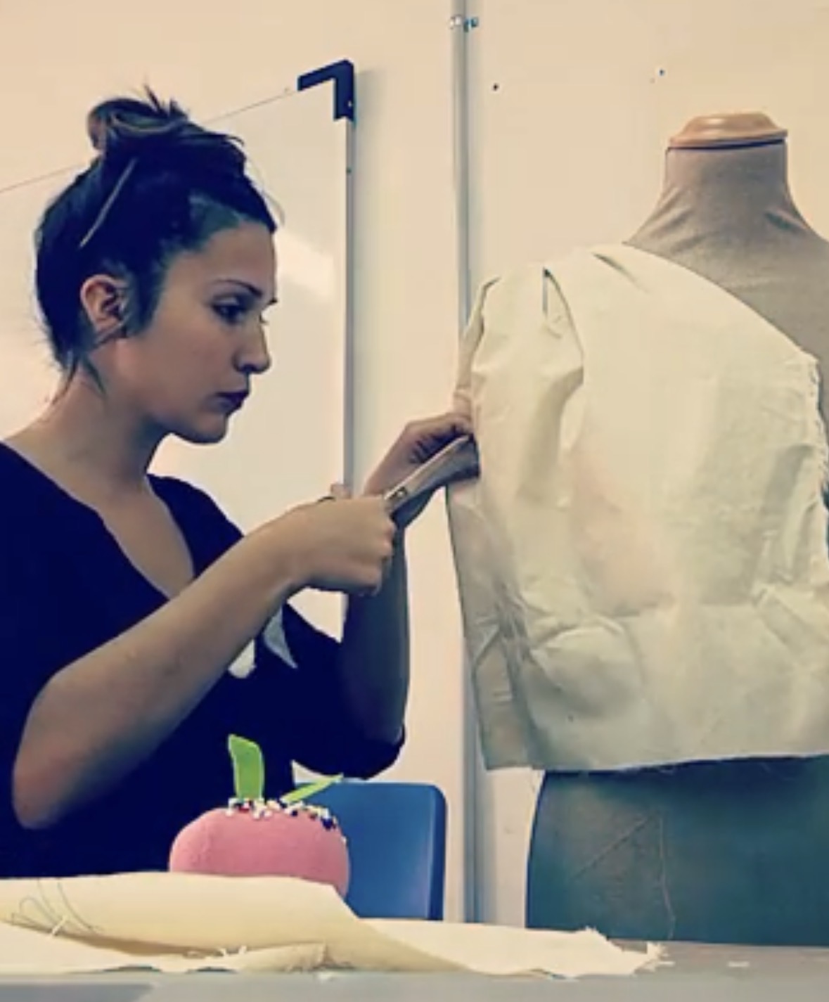 Maya draping on a mannequin at the atelier